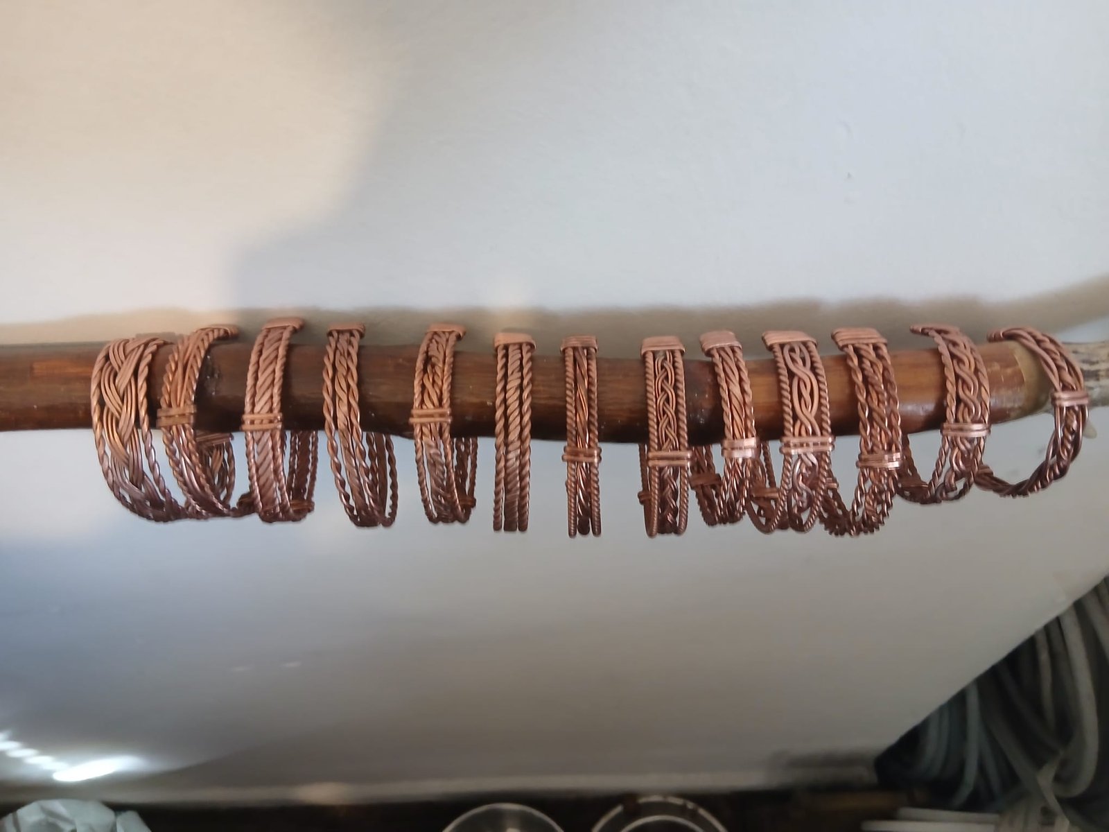 A row of handmade Celtic copper cuffs