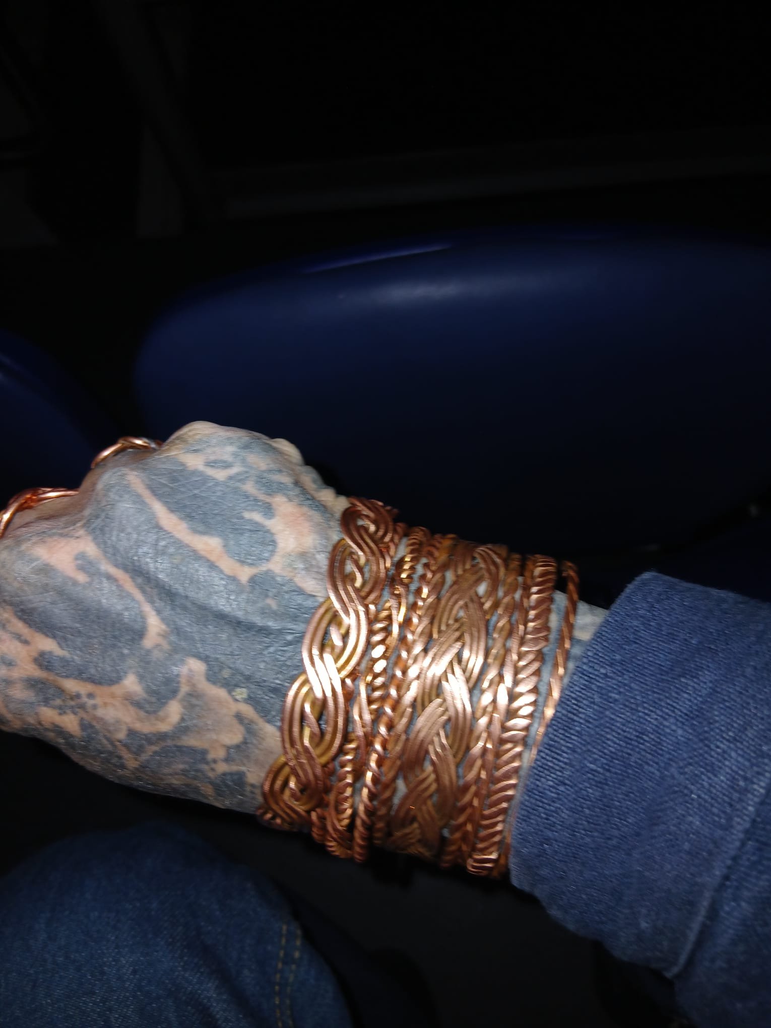 Stacked copper cuffs worn on a wrist
